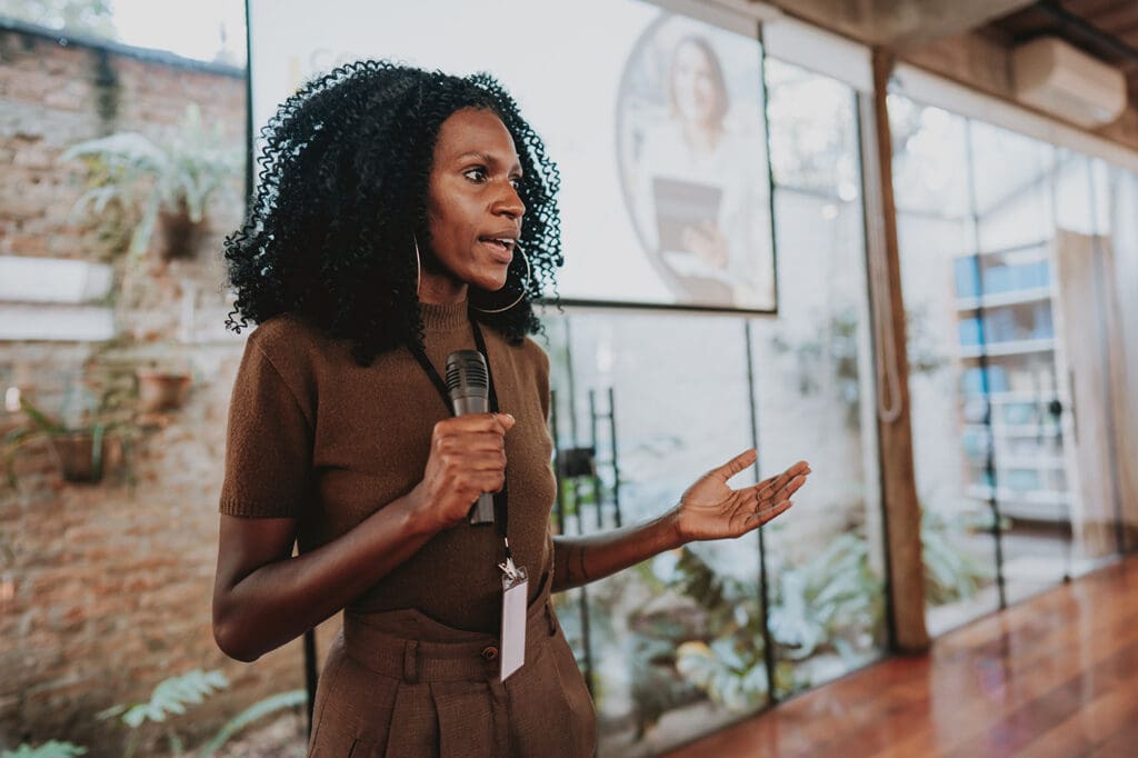 Woman Rehearses Speech at Business Keynote