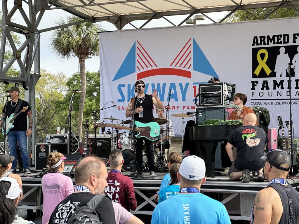 A band performs onstage at the Expo area of Skyway 10k, entertaining participants and spectators alike. 