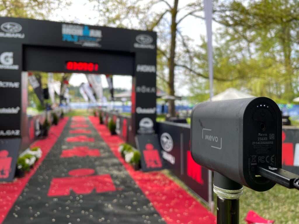 A Mevo camera positioned at the bustling finish line of an Ironman event.