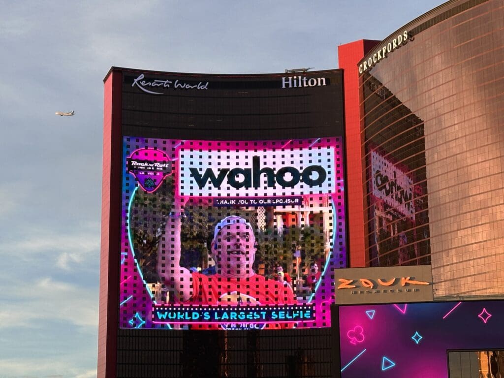 An LED wall displaying a massive selfie taken by a crowd of people. 