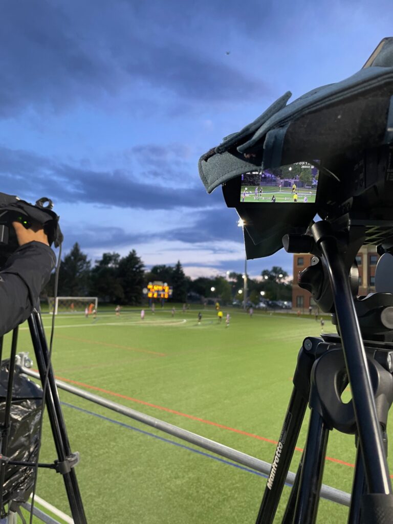 Cameras shooting video at a soccer game