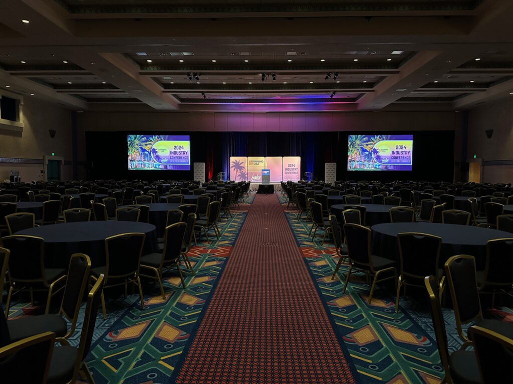 Auditorium set up with audience chairs and projectors.